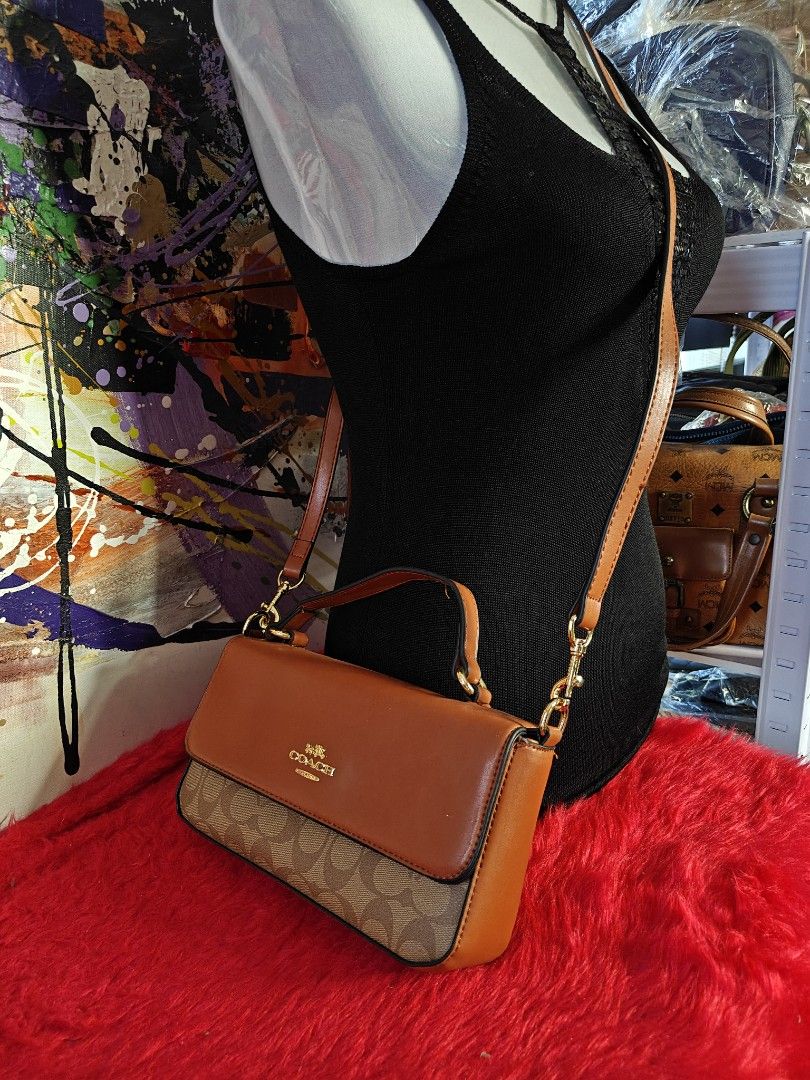 Coach Brown Crossbody Handbag (Category: Luxury Bags & Wallets) located in Las Pinas. Submitted by liezel49 (Listing ID 1435874529, Image 1). Description: - Authentic Coach handbag - Brown leather exterior - Signature Coach pattern on the bottom - Top handle and detachable crossbody strap - Light-colored fabric lining - Interior pocket - Gold-tone hardware - Flap closure.