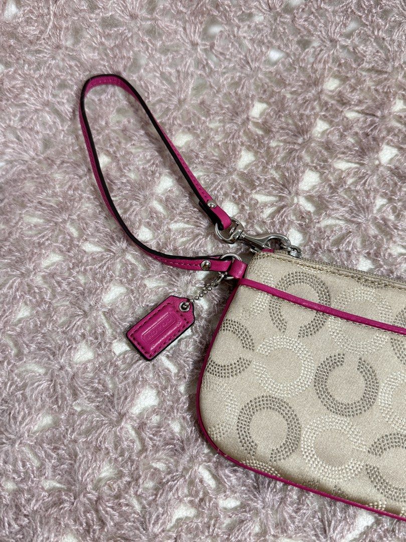 Coach Pink Wristlet (Category: Purses & Pouches) located in Manila. Submitted by livelaughlovejay (Listing ID 1435769429, Image 2). Description: - Coach wristlet - Beige exterior with circle pattern - Pink trim, wrist strap, and tag - Light beige fabric interior - Zipper closure - Silver-tone hardware.