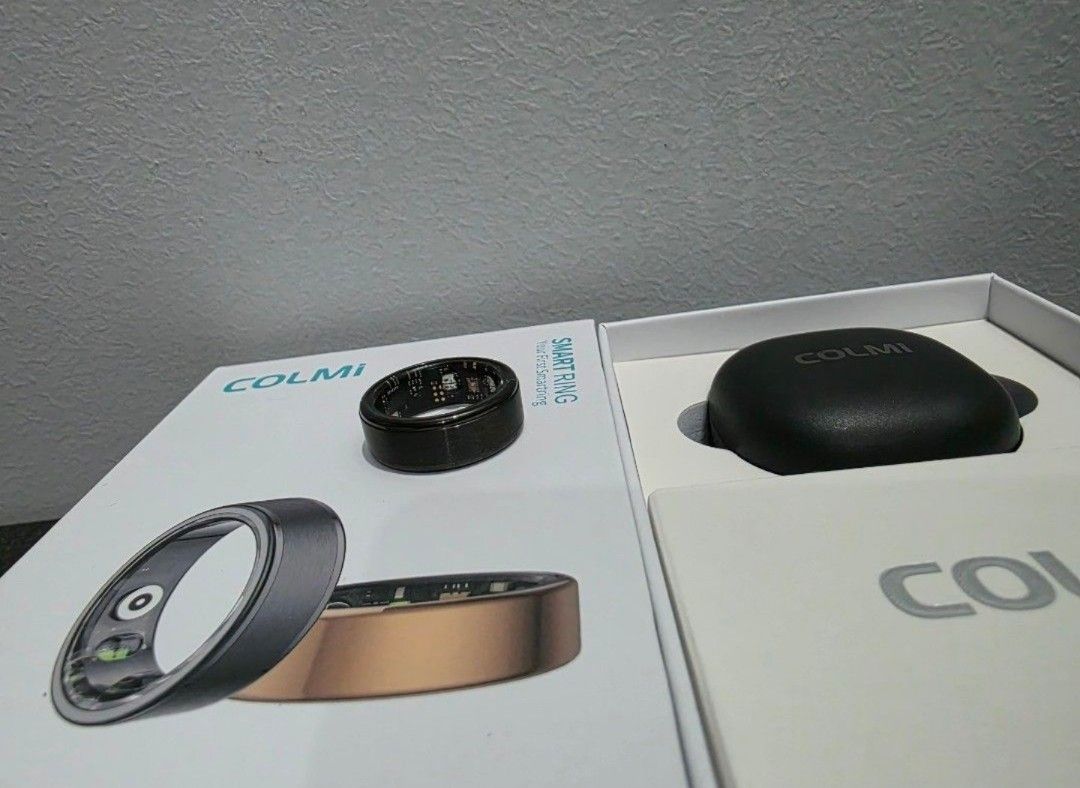 Colmi Smart Ring R03 (Category: Other Gadgets) located in Balagtas. Submitted by asgmatters (Listing ID 1435904633, Image 1). Description: - Colmi Smart Ring Size 8 - Sleek black and gold design - Includes ring, charging case, and user manual - Designed for health and fitness tracking - Features the Colmi logo on the charging case.