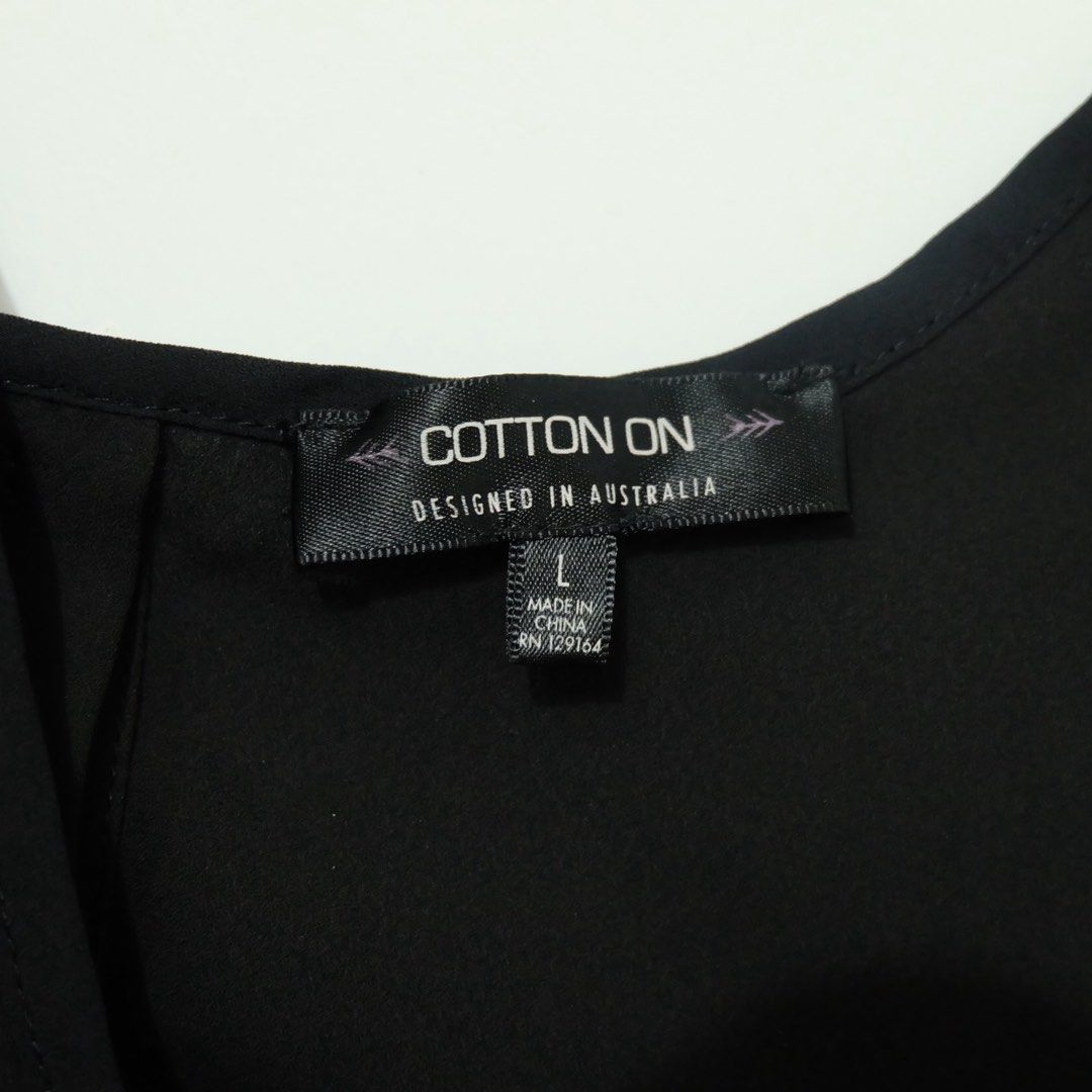 Cotton On Black Sleeveless Button-Back Top (Size L) (Category: Sleeveless) located in Manila. Submitted by thecooldeclutterer (Listing ID 1435859231, Image 3). Description: • Brand: Cotton On • Size: Large (L) • Color: Solid Black • Style: Lightweight sleeveless tank with a scoop neckline and functional button-down back detail • Origin: Designed in Australia; Made in China KEYWORDS Cotton On, Large, Black, Tank, Sleeveless, Button-Back, New, Mini