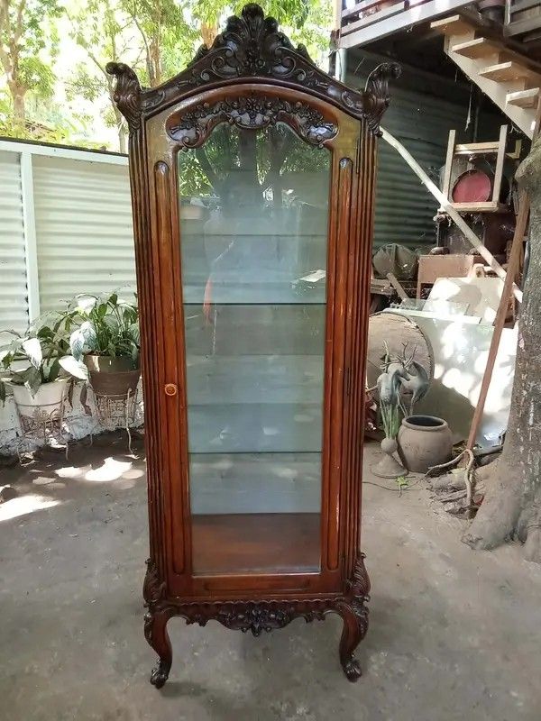 Curio Displayer (Category: Shelves, Cabinets & Racks) located in Manila. Submitted by carmelites36250 (Listing ID 1435762751, Image 3). Description: Old Curio Made of narra wood except backing ply Glass shelves w/ lights Size: L23 W17 H72inch Shelves: 22-16-16inch Selling as is but still presentable Orig patina Ready to use Price: 22,500 Offer:Pick up/ Delivery 🚛.