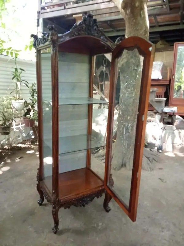 Curio Displayer (Category: Shelves, Cabinets & Racks) located in Manila. Submitted by carmelites36250 (Listing ID 1435762751, Image 2). Description: Old Curio Made of narra wood except backing ply Glass shelves w/ lights Size: L23 W17 H72inch Shelves: 22-16-16inch Selling as is but still presentable Orig patina Ready to use Price: 22,500 Offer:Pick up/ Delivery 🚛.