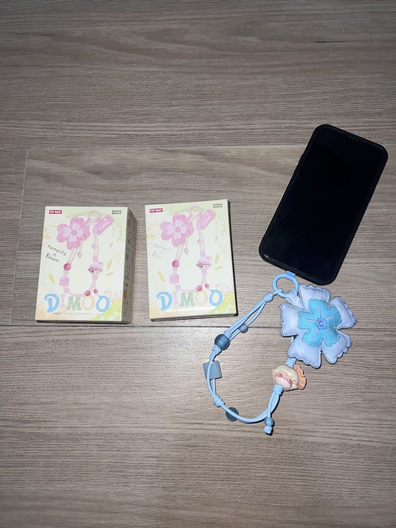 Dimoo Moments in Bloom Phone Charm (Category: Other Mobile & Gadget Accessories) located in Rizal. Submitted by decluttering.mess (Listing ID 1435881982, Image 2). Description: • Popmart • Dimoo Moments in Bloom Phone Charm • sealed box & foil, got this from popmart web pick & shake a box • AVAILABLE: Spring’s Trumpet (Purple) Falling into Flowers (Green) • SUPER GANDA 💓 attached sample actual photos #popmart #dimoo #phonecharm #blindbox.
