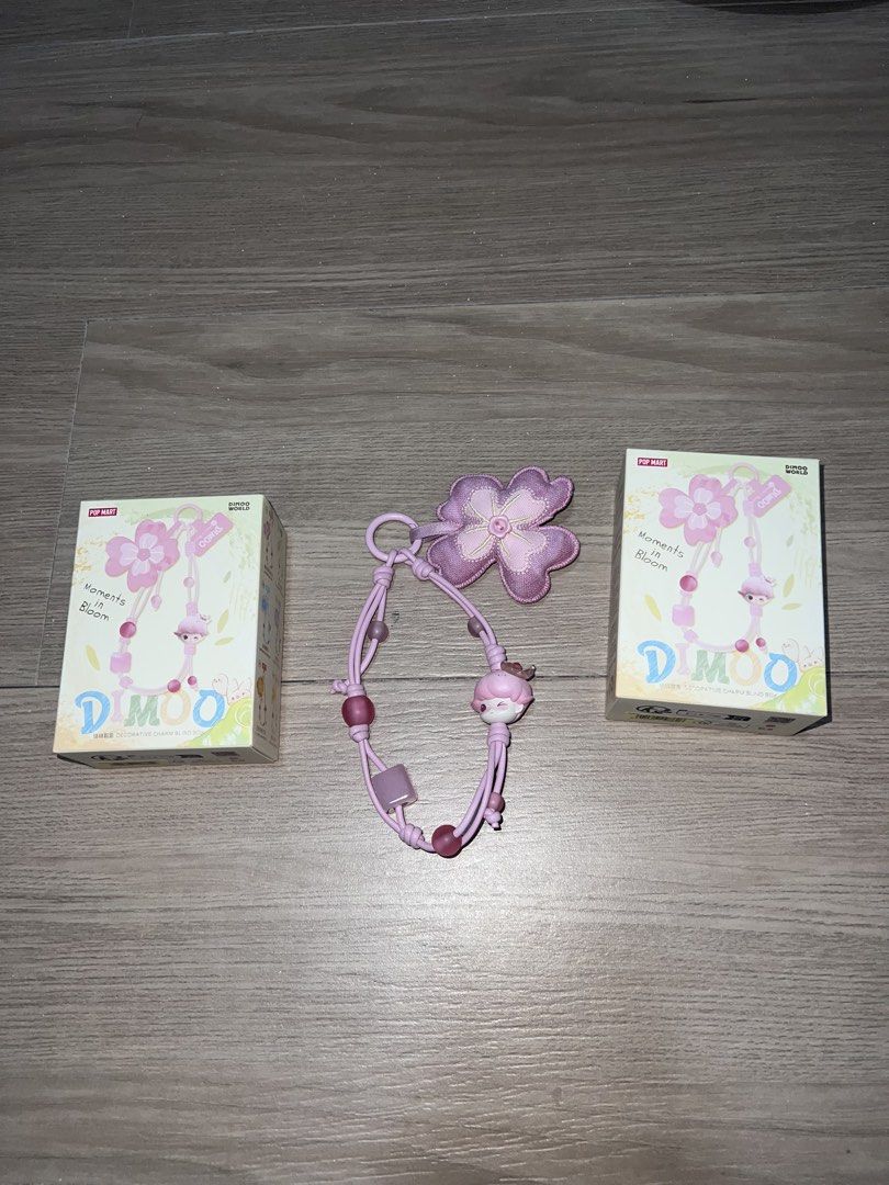Dimoo Moments in Bloom Phone Charm (Category: Other Mobile & Gadget Accessories) located in Rizal. Submitted by decluttering.mess (Listing ID 1435881982, Image 1). Description: • Popmart • Dimoo Moments in Bloom Phone Charm • sealed box & foil, got this from popmart web pick & shake a box • AVAILABLE: Spring’s Trumpet (Purple) Falling into Flowers (Green) • SUPER GANDA 💓 attached sample actual photos #popmart #dimoo #phonecharm #blindbox.
