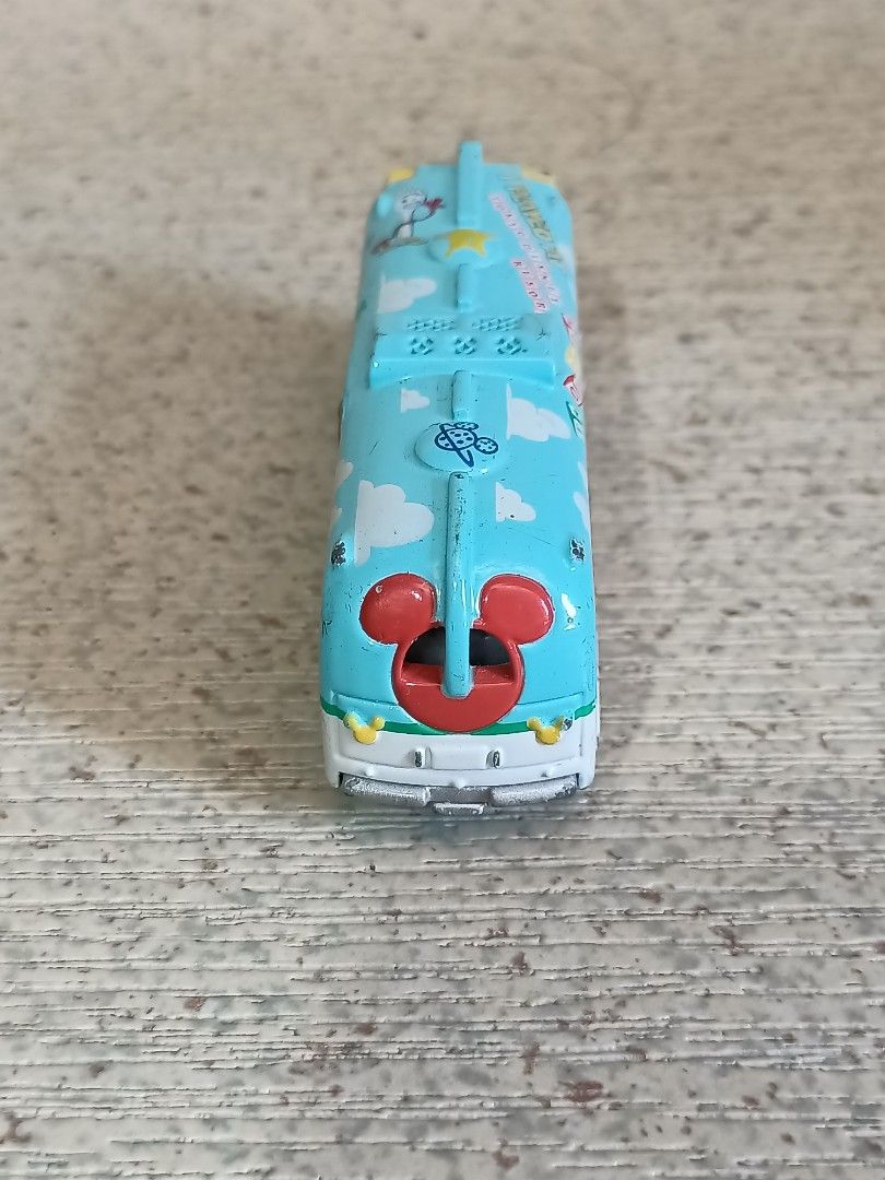 Disney Pixar Toy Story Bus (Category: Vehicle & Diecast Models) located in Quezon City. Submitted by Bernz (Listing ID 1435765639, Image 3). Description: - Toy Story themed bus toy - Light blue body with Toy Story character designs - Mickey Mouse design on the back - Opening door - White and yellow interior.