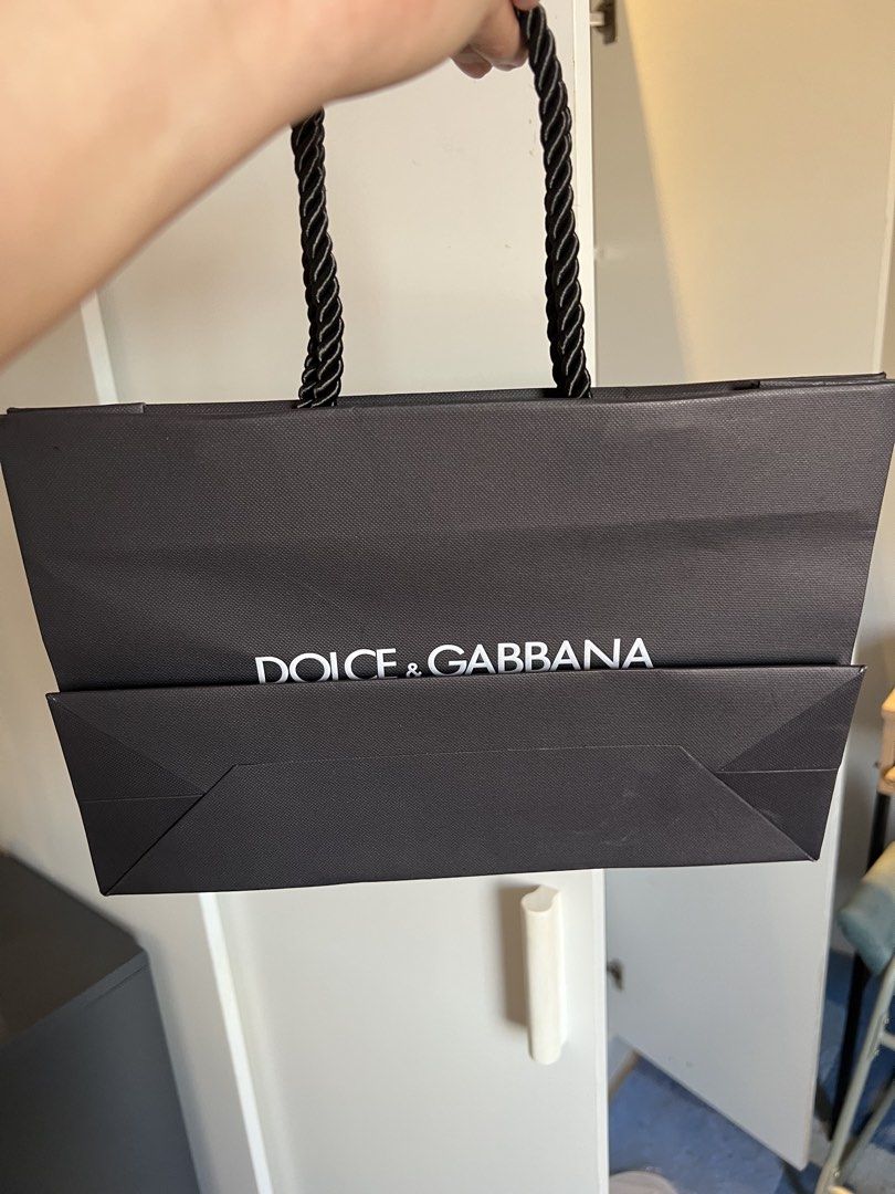 Dolce & Gabbana Shopping Bag (Category: Luxury Bags & Wallets) located in Makati City. Submitted by marckyboy (Listing ID 1435813328, Image 2). Description: - Authentic Dolce & Gabbana shopping bag - Black paper exterior - White Dolce & Gabbana logo - Features black rope handles - Ideal for gifting or collecting.