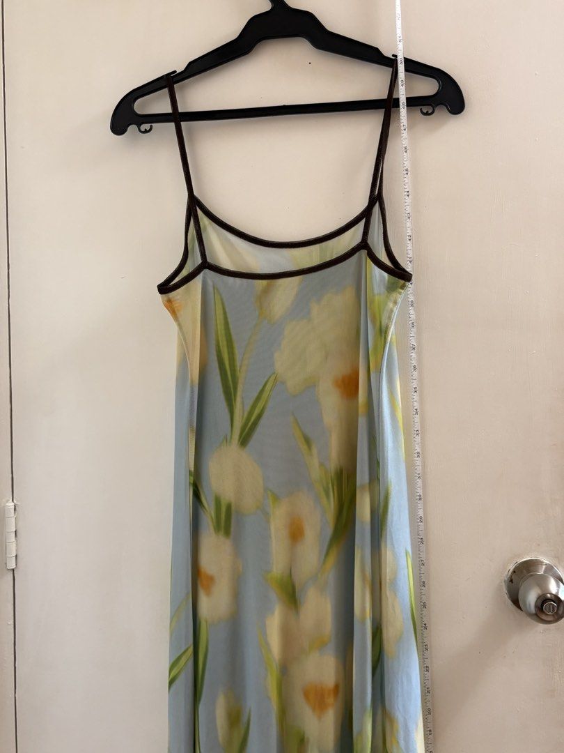 Floral Print Spaghetti Strap Dress (Category: Dresses) located in Dasmarinas. Submitted by marii. (Listing ID 1435880295, Image 1). Description: - Floral maxi dress - Delicate yellow and green floral print on light blue background - Spaghetti straps - Mesh overlay - Dark brown trim on neckline and straps - S-M.