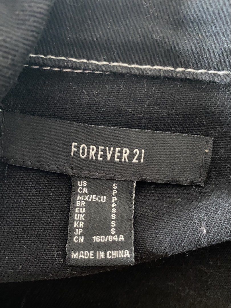 Forever 21 Black Denim Moto Jacket (Category: Coats, Jackets and Outerwear) located in Gapan. Submitted by sonikku (Listing ID 1435833185, Image 2). Description: - Forever 21 Black Denim Moto Jacket - Size: S - Features: - White stitching details - Classic moto collar - Zipper closure - Material: 100% Cotton - Made in China - Style: Edgy and classic.