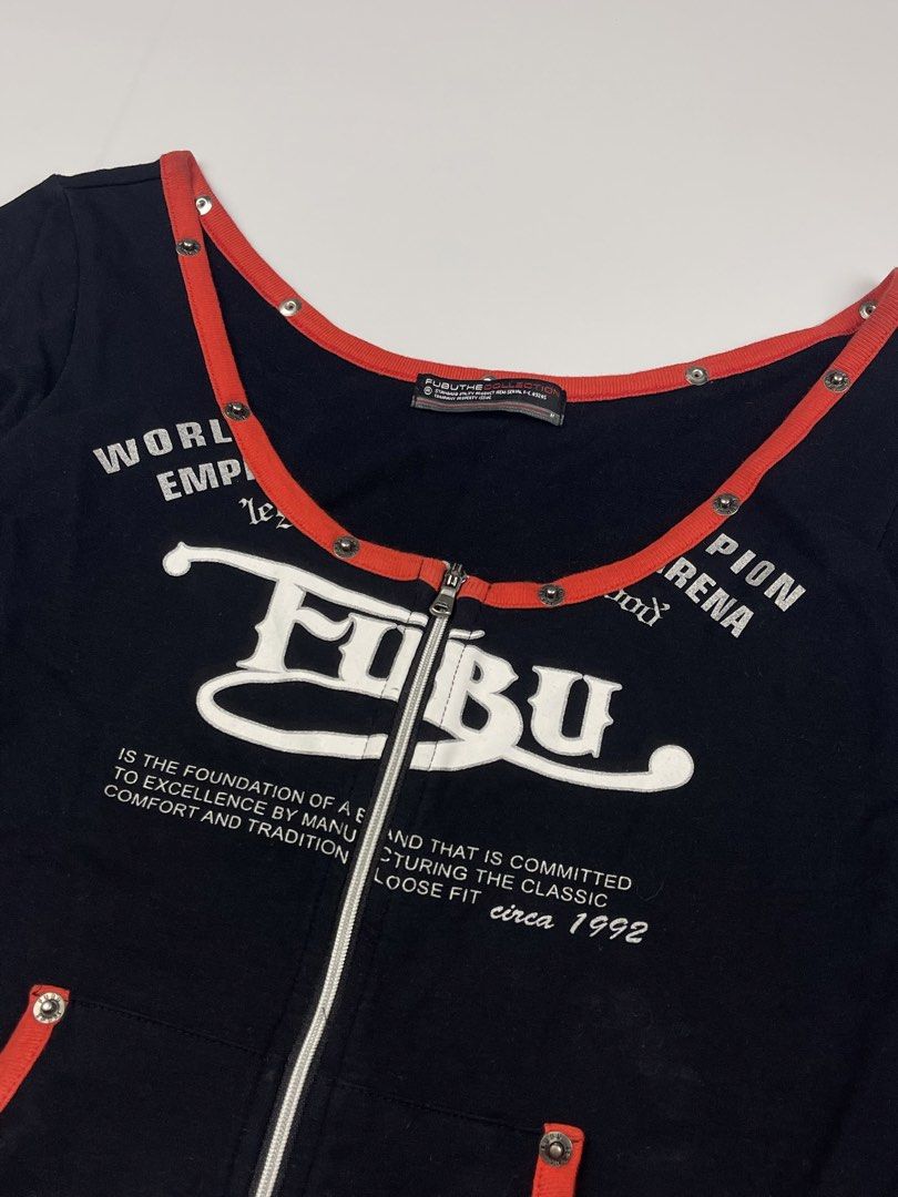 FUBU Vintage Graphic Zip-Up Top (Category: Longsleeves) located in Cagayan de Oro. Submitted by kmcurations (Listing ID 1435861287, Image 3). Description: FUBU Vintage Graphic Zip-Up Top • Price: PHP 300 • Brand: FUBU The Collection • Design: Rare vintage-style long-sleeve top featuring a full zip-up front and a deep, rounded off-shoulder neckline • Color: Classic black with vibrant red contrast trim • Features: • Large white FUBU logo graphic on