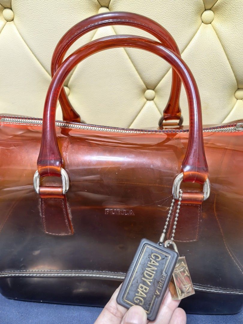 Furla Candy Bag (Category: Luxury Bags & Wallets) located in Makati City. Submitted by reiven2017 (Listing ID 1435817422, Image 1). Description: - Authentic Furla Candy Bag - Gradient design - Red handles - Zipper closure - Detachable tag - Silver-tone lock charm - Transparent body with dark base - Medium size.