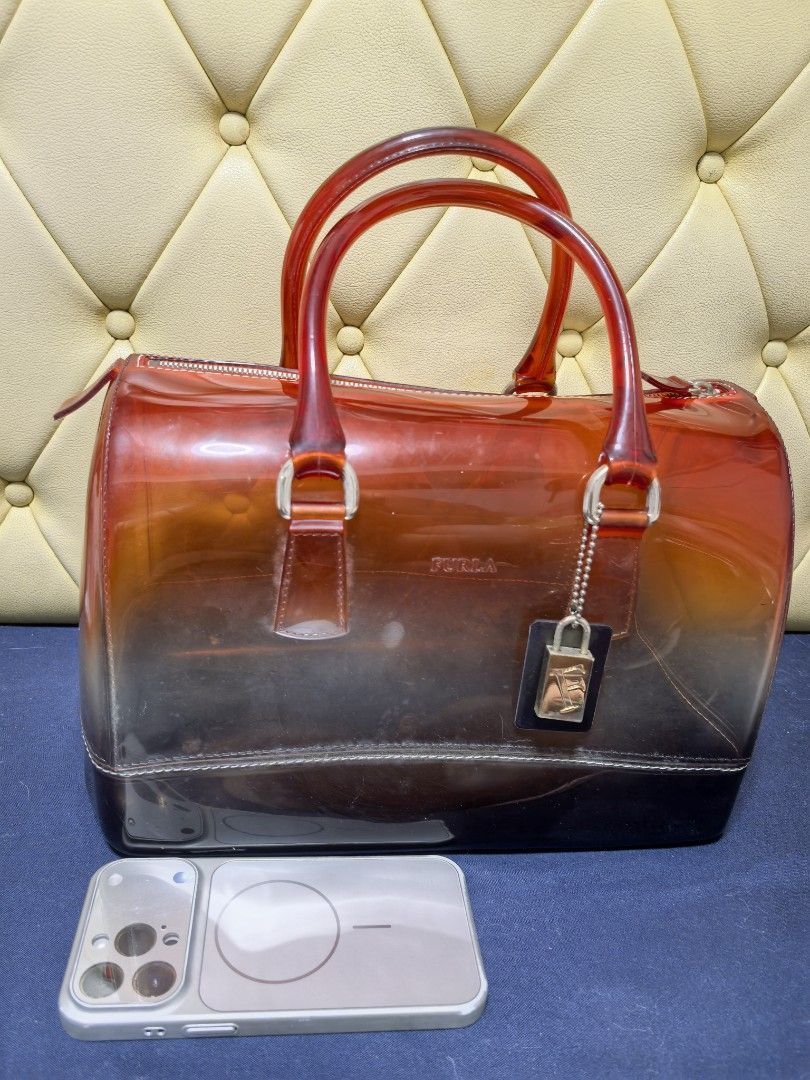 Furla Candy Bag (Category: Luxury Bags & Wallets) located in Makati City. Submitted by reiven2017 (Listing ID 1435817422, Image 3). Description: - Authentic Furla Candy Bag - Gradient design - Red handles - Zipper closure - Detachable tag - Silver-tone lock charm - Transparent body with dark base - Medium size.