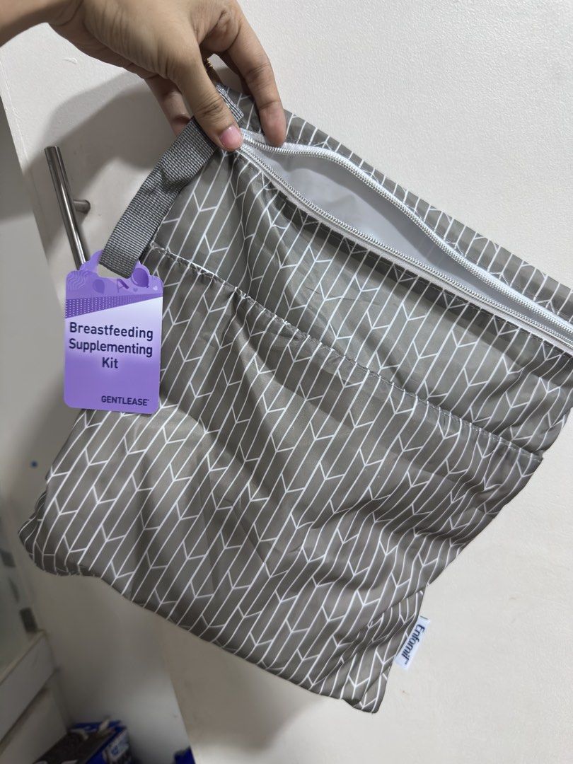 Gentlease Breastfeeding Supplementing Kit (Category: Breastfeeding & Bottle Feeding) located in Rizal. Submitted by GirlDeclutter (Listing ID 1435824969, Image 2). Description: - New Gentlease Breastfeeding Supplementing Kit - Stylish gray and white geometric design - Includes main bag with zipper - Separate smaller pouch included - Convenient handle for carrying - Brand new and sealed.