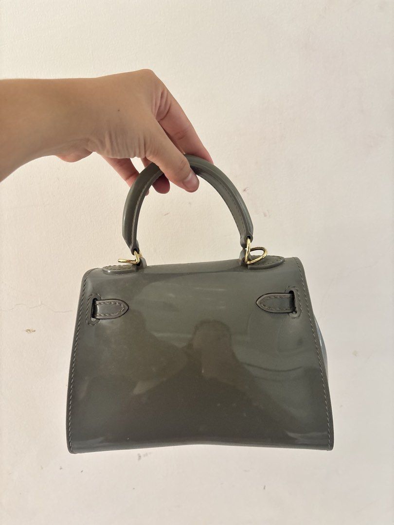 Grey Mini Handbag with Top Handle (Category: Luxury Bags & Wallets) located in Bulacan. Submitted by mreyes21 (Listing ID 1435775195, Image 2). Description: - Mini handbag - Glossy grey finish - Top handle - Rectangular shape - Flap closure - Gold-colored hardware - Compact size - Detachable strap - Ideal for carrying essentials.
