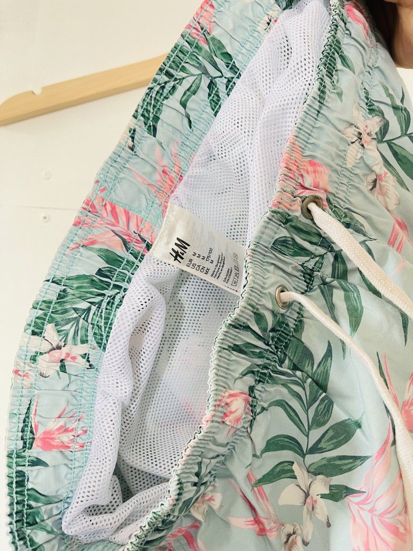 H&M Floral Swim Shorts (Category: Shorts) located in Cotabato. Submitted by aripov11 (Listing ID 1435745849, Image 3). Description: - H&M swim shorts - Size: M - Color: Light blue base with pink and green floral pattern - Features: Drawstring waist, mesh lining.
