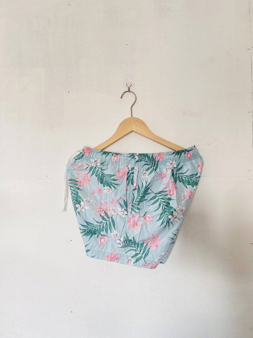 H&M Floral Swim Shorts (Category: Shorts) located in Cotabato. Submitted by aripov11 (Listing ID 1435745849, Image 2). Description: - H&M swim shorts - Size: M - Color: Light blue base with pink and green floral pattern - Features: Drawstring waist, mesh lining.