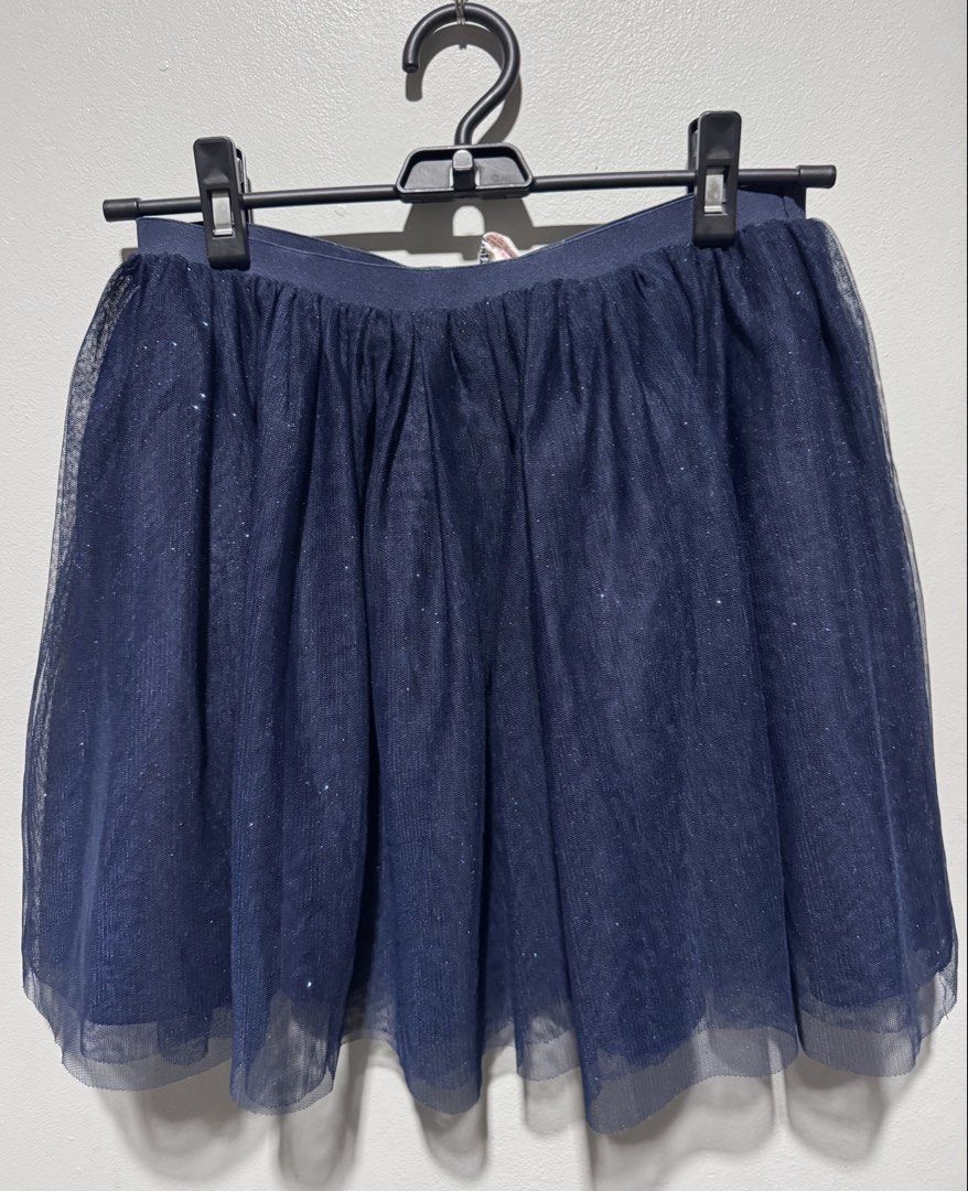 H&M Navy Blue Tulle Skirt (Category: Babies & Kids Fashion) located in General Trias. Submitted by lessleesell (Listing ID 1435883747, Image 1). Description: - Navy blue tulle skirt - Sparkly finish - Layered design - Comfortable elastic waistband - Versatile for parties or everyday wear 9-10 on tag. May fit from 7y.