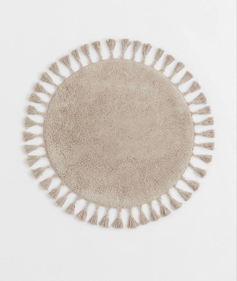 H&M Round Tassel Greige Bath Mat Rug (Category: Carpets, Mats & Flooring) located in Marikina City. Submitted by preloved.mana (Listing ID 1435902201, Image 1). Description: - Round, Diameter: 28in / 70cm - Greige color - tassels around the edge - cotton material - anti slip protector at back - washed once, cause of slight discoloration in some parts - still good quality, no loose threads and intact tassels -MOP: gcash, maya, bpi qr - MOD: lalamo