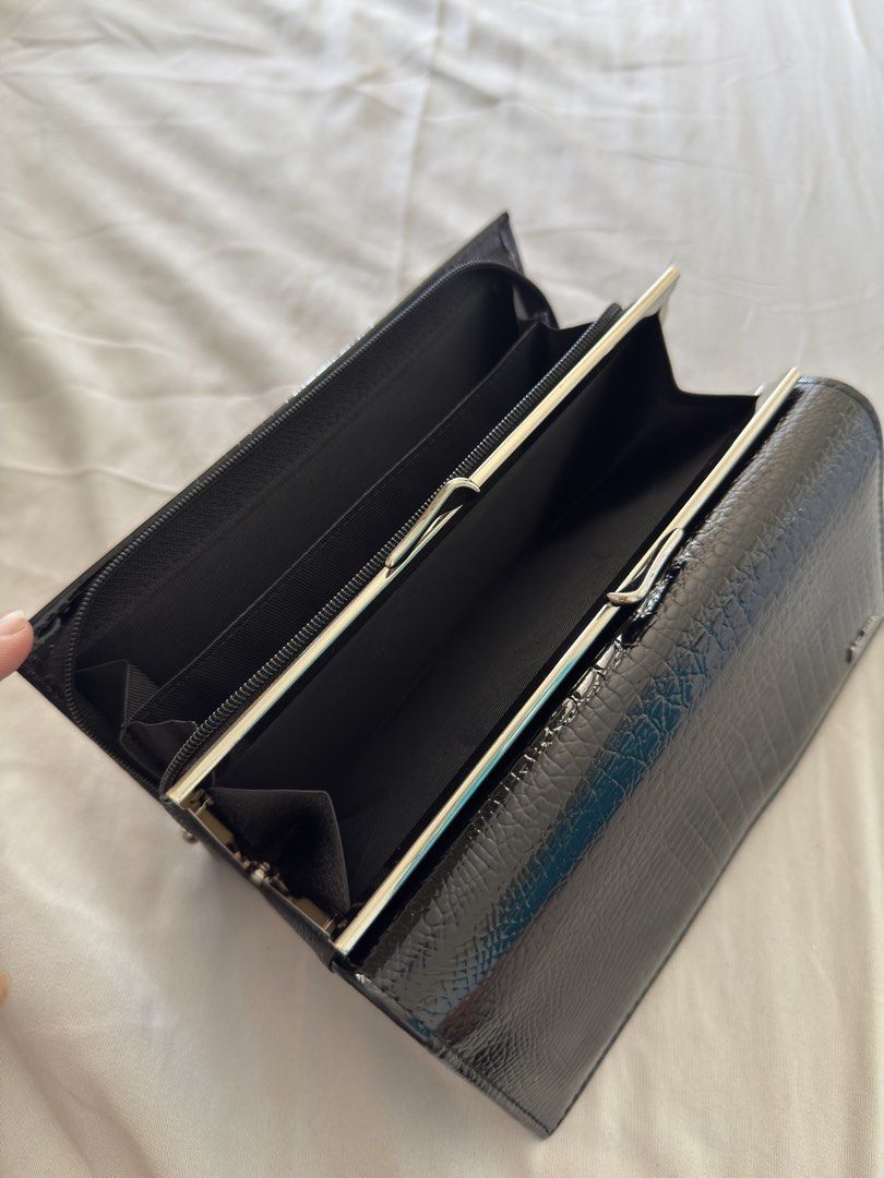 Hongliang Black Crocodile Wallet (Category: Luxury Bags & Wallets) located in Makati City. Submitted by thisisshy (Listing ID 1435782300, Image 3). Description: - Black wallet with crocodile skin pattern - Brand: Hongliang - Multiple compartments for cards and cash - Includes a clear ID window - Zippered pocket for secure storage - Features both snap and clasp closures.