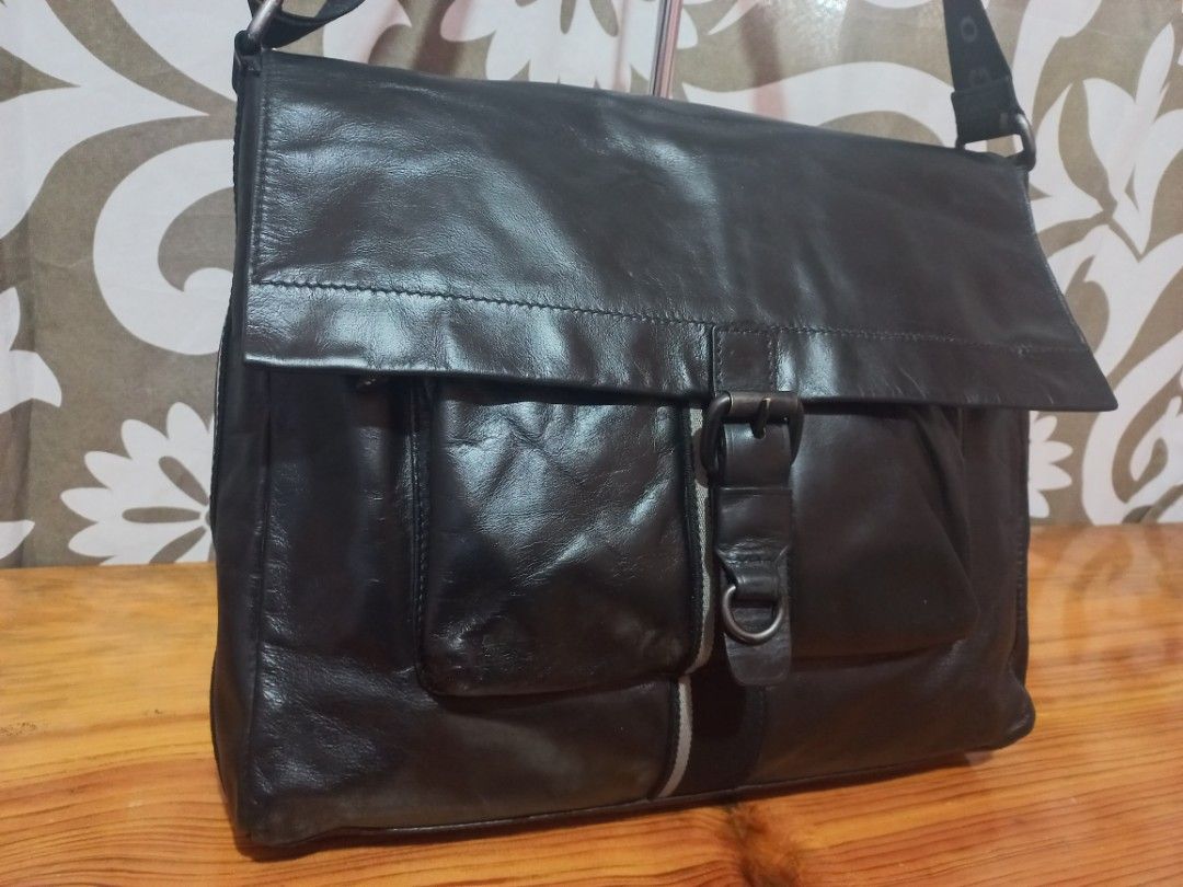 Hugo Boss Black Leather Messenger Bag (Category: Luxury Bags & Wallets) located in Baguio. Submitted by highticket75 (Listing ID 1435735776, Image 3). Description: - Hugo Boss Black leather messenger - Flap with buckle closure - Adjustable shoulder strap - Front zip pocket -H 11', W 13.5", Base 3.25" - Multiple inside pockets - Vertical stripe detail.