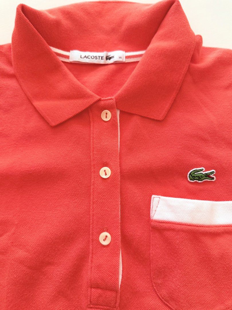 Lacoste Coral Polo Shirt (Category: Shirts) located in Makati City. Submitted by eyes_jade (Listing ID 1435910296, Image 3). Description: - Authentic Lacoste polo shirt - Coral color - Size 36 - Pocket with white trim - White trim on sleeves - Classic polo collar - Button-up placket - Lacoste logo on chest.