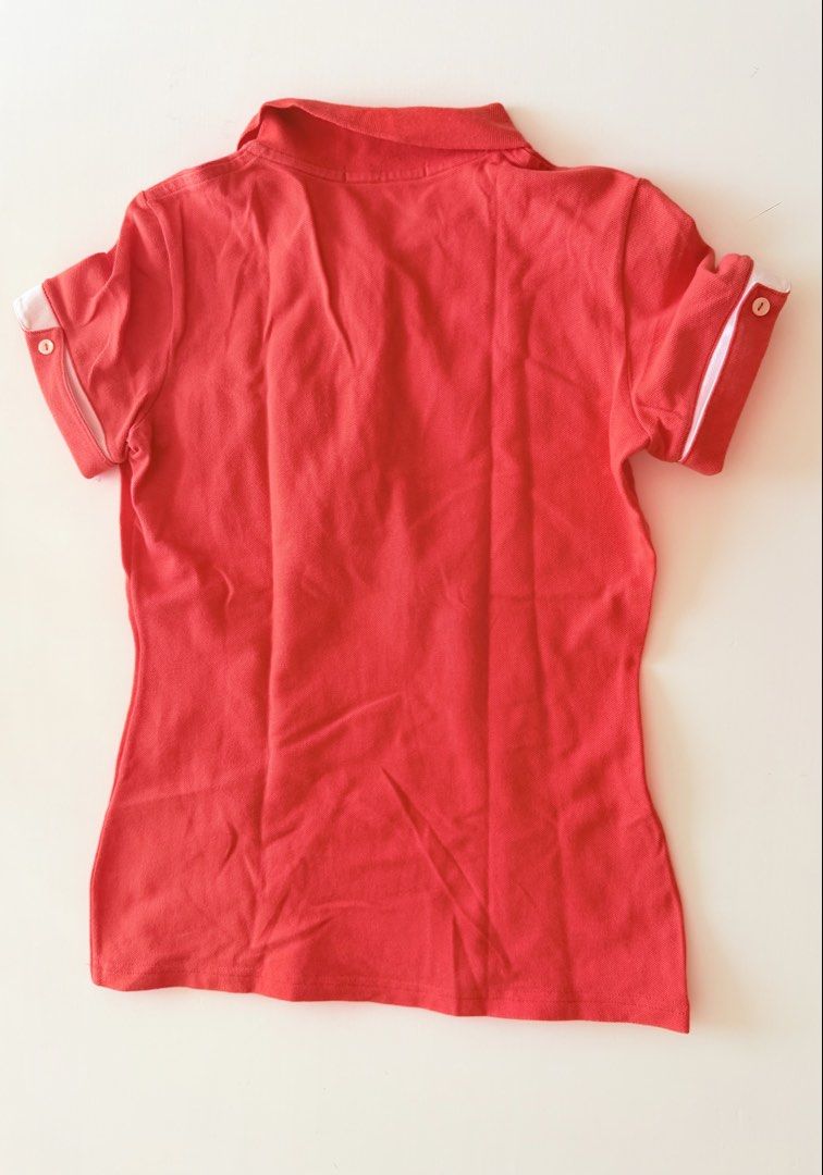 Lacoste Coral Polo Shirt (Category: Shirts) located in Makati City. Submitted by eyes_jade (Listing ID 1435910296, Image 2). Description: - Authentic Lacoste polo shirt - Coral color - Size 36 - Pocket with white trim - White trim on sleeves - Classic polo collar - Button-up placket - Lacoste logo on chest.