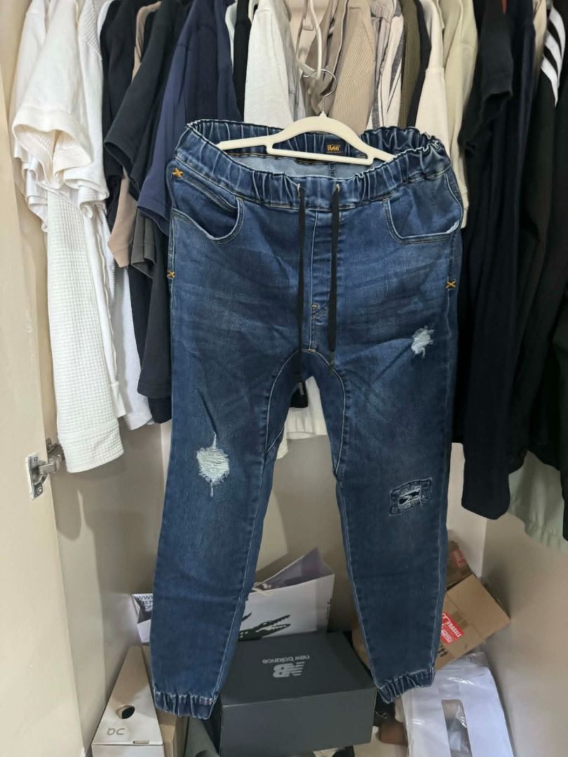 Lee Denim Jogger Jeans (Category: Jeans) located in Las Pinas. Submitted by phil.declutters (Listing ID 1435807575, Image 1). Description: - Lee dark blue denim jogger jeans - Dark blue wash - Drawstring waist - Front pockets - Relaxed fit - Cuffed ankles - Distressed detailing: rips on front legs, patch on right leg.