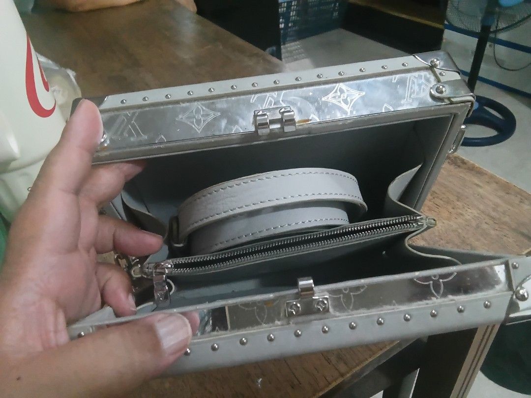 Louis Vuitton Mirror hard Trunk Bag (Category: Luxury Bags & Wallets) located in Bacoor. Submitted by tgkcac (Listing ID 1435729312, Image 3). Description: - Used Louis Vuitton mirror hard trunk bag - Japan Haul - Mirrored exterior with iconic LV monogram - Features silver-tone hardware - Includes a stylish chain strap - Interior has a zippered pocket - Comes with a detachable strap for versatility - Structured, boxy design.