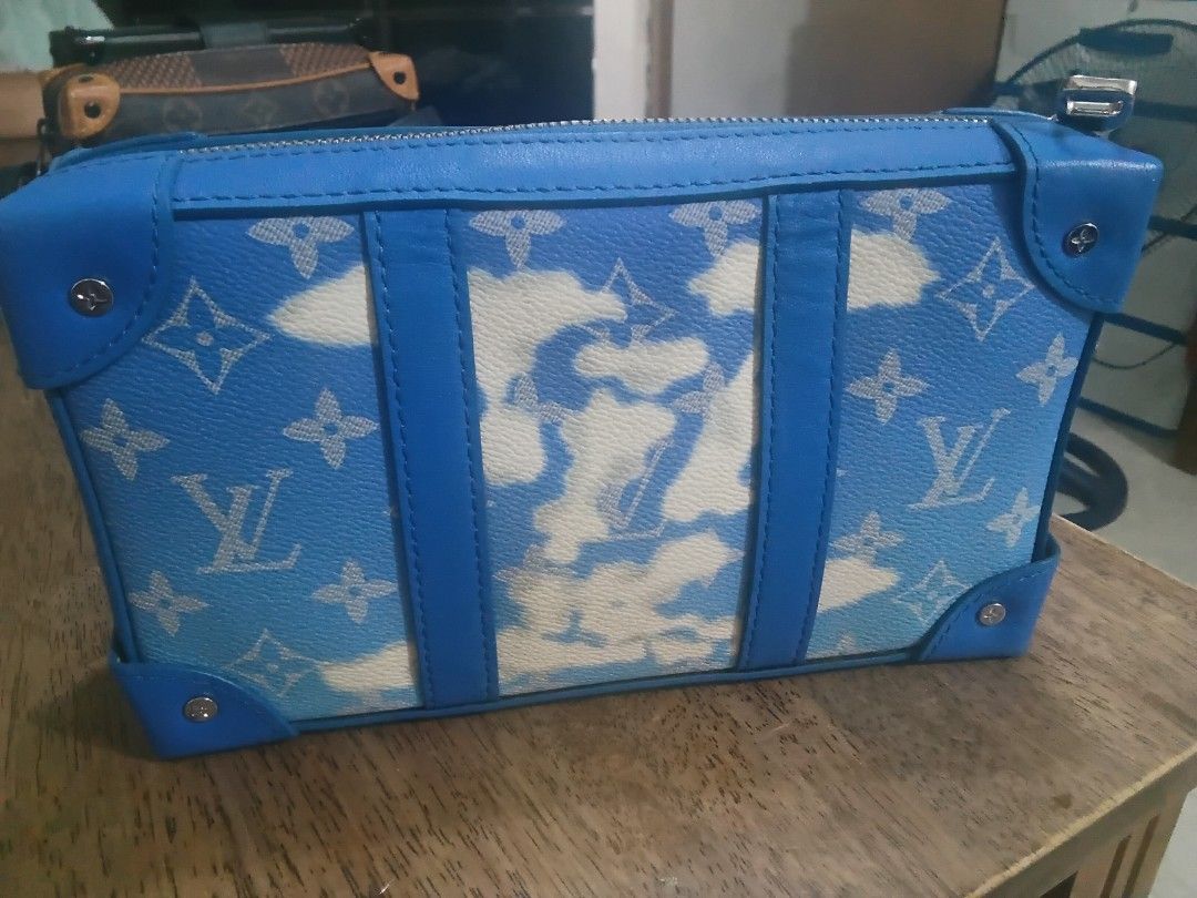 Louis Vuitton Soft Trunk Messenger Bag (Category: Luxury Bags & Wallets) located in Bacoor. Submitted by tgkcac (Listing ID 1435729813, Image 2). Description: - Louis Vuitton Soft Trunk clutch Bag - Japan Haul - Eye-catching blue and white cloud pattern - Blue leather trim - Silver zipper - Includes shoulder strap - Multiple interior compartments - Features the iconic Louis Vuitton monogram.