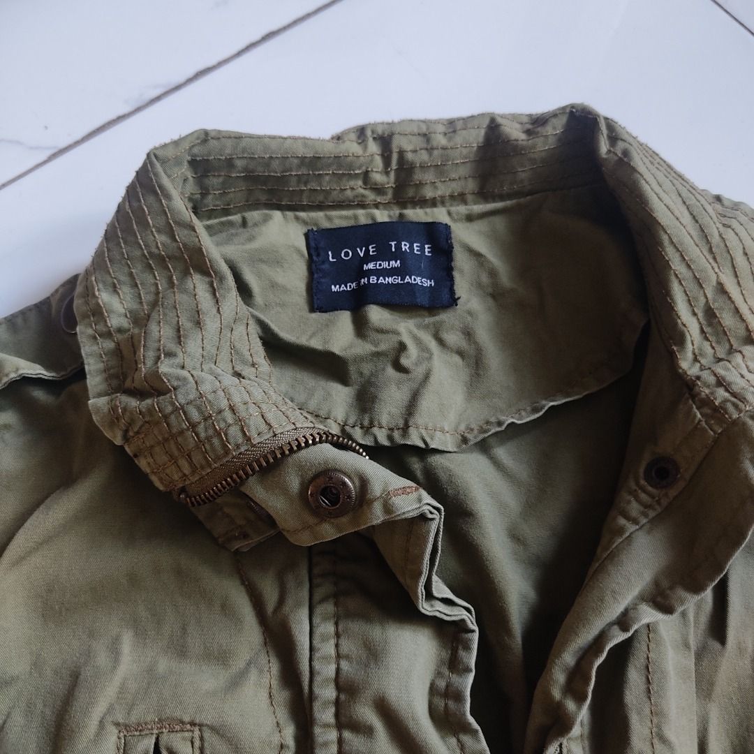 Love Tree Olive Green Jacket (Category: Coats, Jackets and Outerwear) located in San Antonio. Submitted by miscorpion (Listing ID 1435799438, Image 3). Description: S-M Rfs: closet reset - Olive green jacket - Collared neckline - Button-down/zipper closure - Multiple pockets - Long sleeves with buttoned cuffs - Lightweight fabric - Tailored fit - Classic, military-inspired design Buyer will shoulder sf N.E loc.