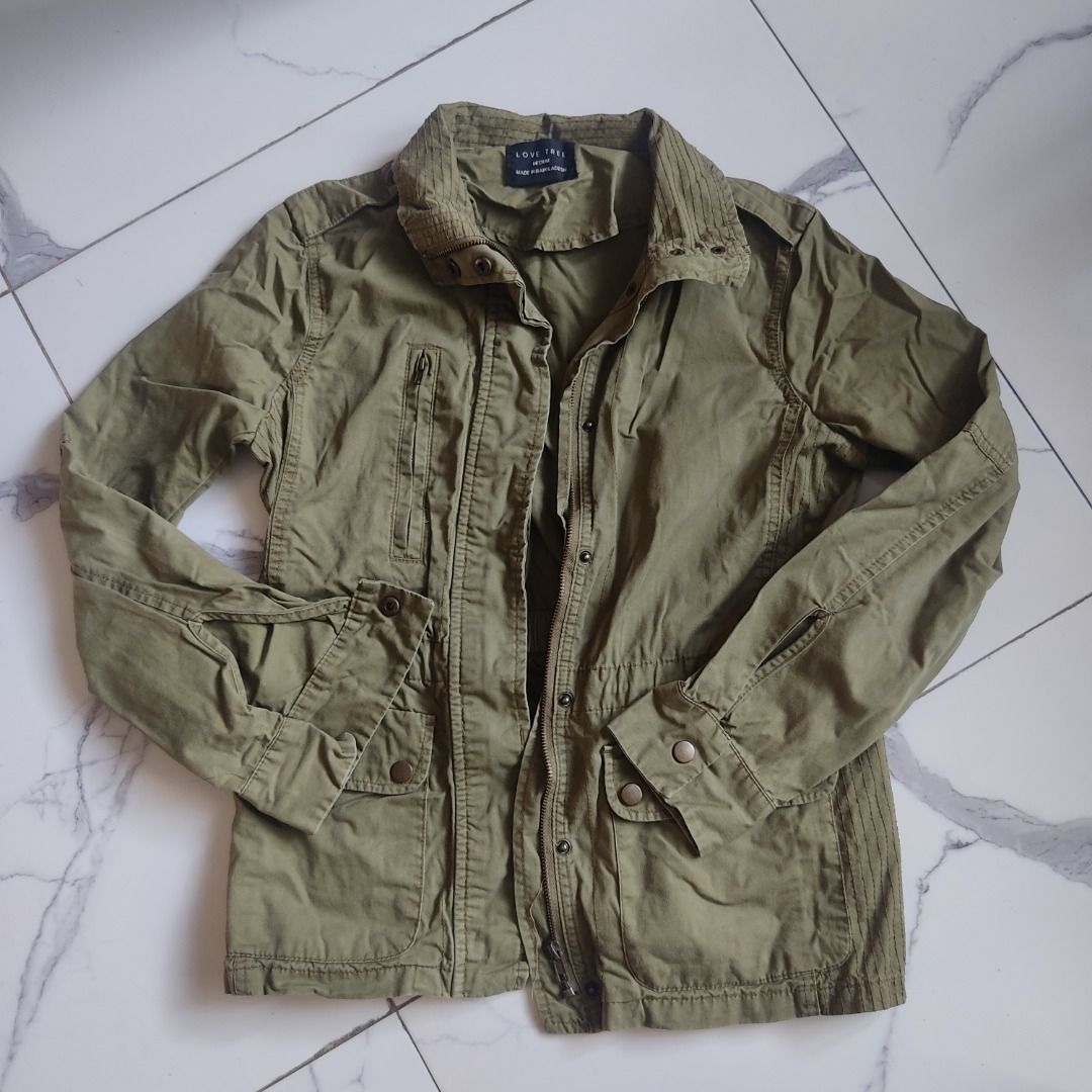 Love Tree Olive Green Jacket (Category: Coats, Jackets and Outerwear) located in San Antonio. Submitted by miscorpion (Listing ID 1435799438, Image 1). Description: S-M Rfs: closet reset - Olive green jacket - Collared neckline - Button-down/zipper closure - Multiple pockets - Long sleeves with buttoned cuffs - Lightweight fabric - Tailored fit - Classic, military-inspired design Buyer will shoulder sf N.E loc.
