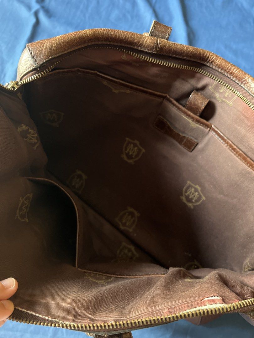 Massimo Dutti Men’s bag Vintage briefcase original (Category: Luxury Bags & Wallets) located in Mandaluyong City. Submitted by moonywinks (Listing ID 1435720415, Image 3). Description: RFS: no longer using, bought it for 10k++ Brown pebbled (grained) bovine leather with antique gold-tone hardware This bag is a Massimo Dutti brown pebbled leather briefcase or travel bag. It is distinguished by the brand’s signature embossed crest logo featuring a 