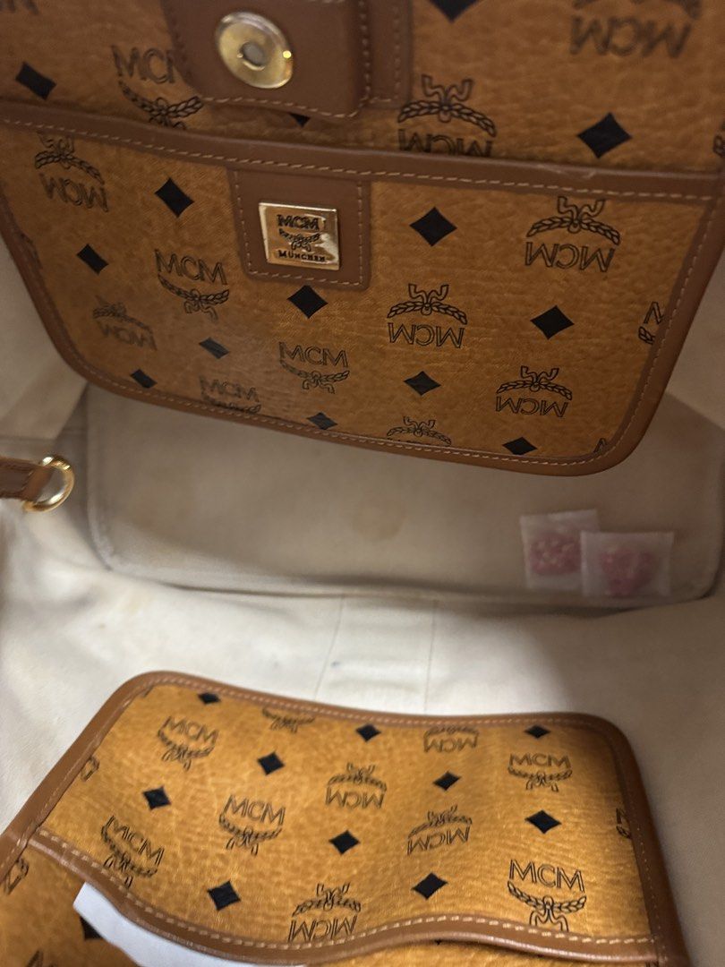 MCM Visetos Coated Canvas Tote Bag (Category: Luxury Bags & Wallets) located in Caloocan City. Submitted by r_h_e_a10 (Listing ID 1435864390, Image 3). Description: - Authentic MCM tote bag - Iconic Visetos coated canvas with center stripe - Brown leather handles and trim - Gold-tone metal logo plate - Interior pocket - Includes certificate of authenticity - Light-colored interior lining.