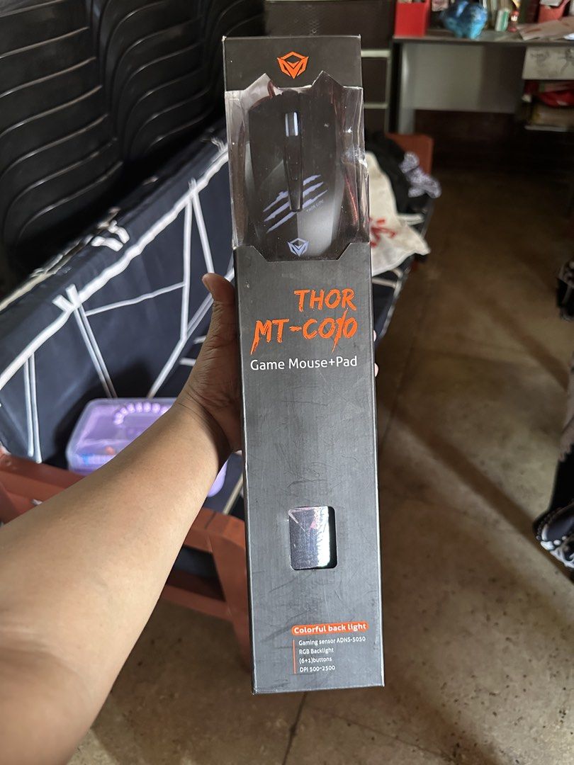 MeeTion THOR MT-C010 Gaming Mouse and Pad (Category: Mouse & Mousepads) located in Marikina City. Submitted by patriciaoriendo2 (Listing ID 1435752676, Image 1). Description: MeeTion THOR MT-C010 gaming mouse and pad combo. Includes a mouse with colorful back light and a scaled-down size mouse pad. The mouse has forward and backward buttons. The mouse pad has a red and black design. The mouse connects via USB..