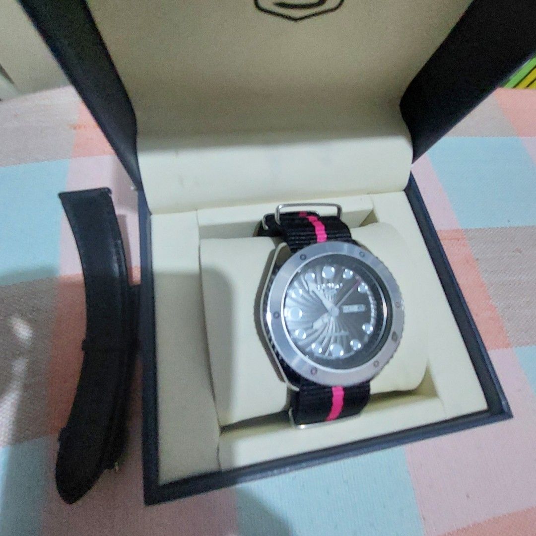 MEN s Watch (Category: Men's Watches) located in Antipolo. Submitted by uncovidspace (Listing ID 1435857256, Image 2). Description: - Seiko 5 watch (premium copy) - Black dial - Silver bezel - Day-date display - Black and pink striped strap - Additional black leather strap - Comes with original box note: need to change battery due to not being used .