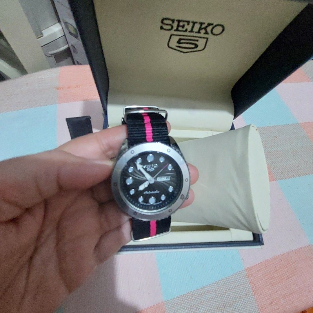 MEN s Watch (Category: Men's Watches) located in Antipolo. Submitted by uncovidspace (Listing ID 1435857256, Image 3). Description: - Seiko 5 watch (premium copy) - Black dial - Silver bezel - Day-date display - Black and pink striped strap - Additional black leather strap - Comes with original box note: need to change battery due to not being used .