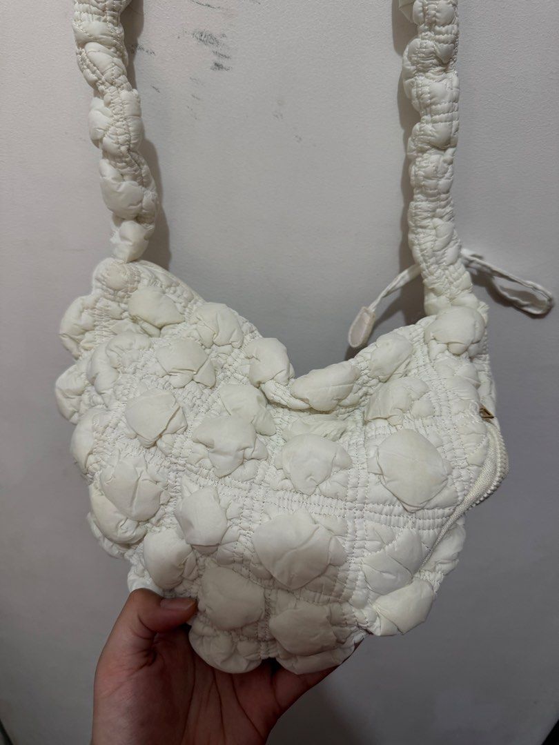 Muji White Puffy Shoulder Bag (Category: Shoulder Bags) located in Mandaluyong City. Submitted by chescacruzz (Listing ID 1435726787, Image 1). Description: - White puffy shoulder bag - Long strap for comfortable wear - Zipper closure - Quilted, bubble-like texture - Stylish and eye-catching design.