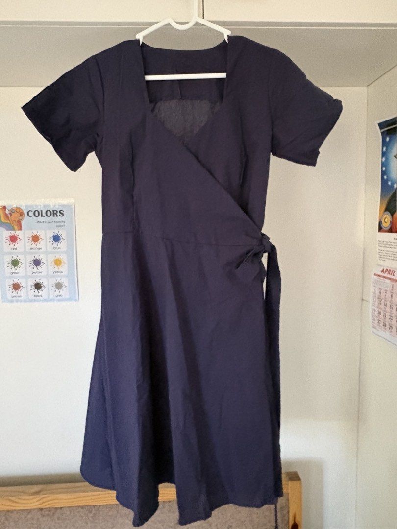 Navy Wrap Dress (Category: Dresses) located in Muntinlupa City. Submitted by take2mnl (Listing ID 1435909339, Image 1). Description: - Navy wrap dress - Fits small to medium - Linen fabric - Short sleeves - Square neckline - Tie waist closure - Flared skirt - Solid woven fabric - Suitable for various occasions.