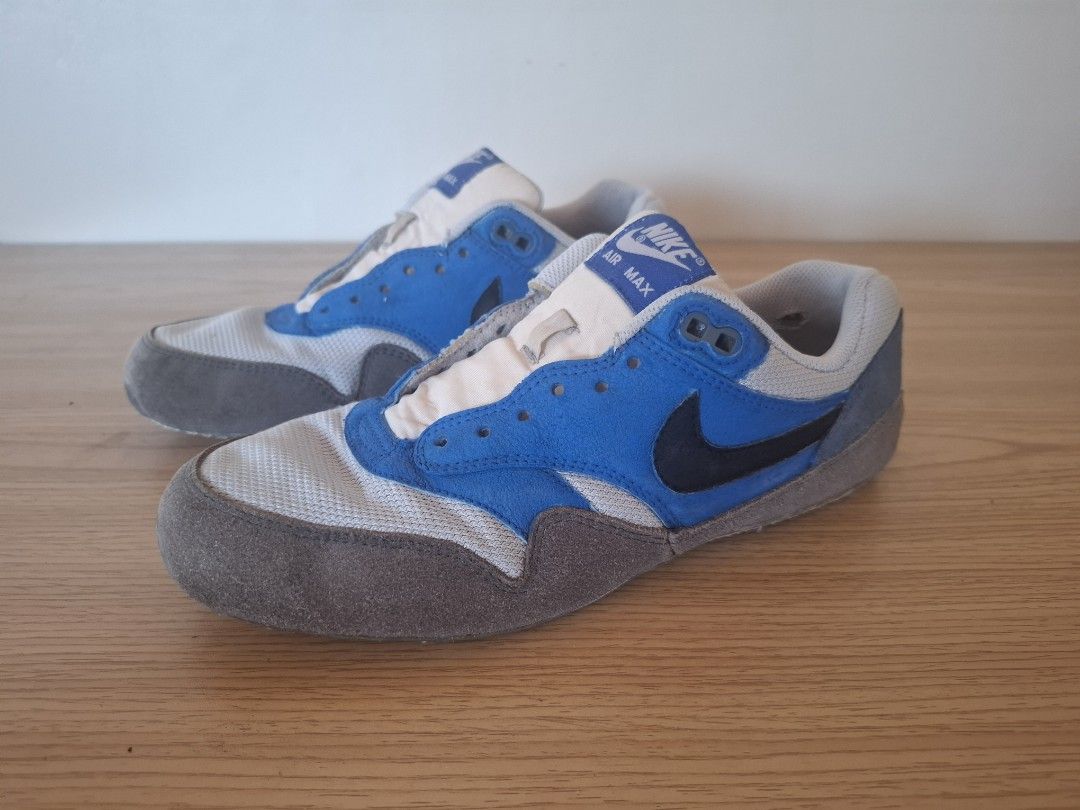 Nike Air Max 1 Sneakers Open for Swapping (Category: Sneakers) located in Quezon City. Submitted by sgtshae (Listing ID 1435810615, Image 2). Description: - Nike Air Max 1 sneakers - Color: Blue, white, and grey - Iconic Nike swoosh - Signs of wear on soles - Blue and white tongue - Grey toe cap - Nike Air logo on heel.