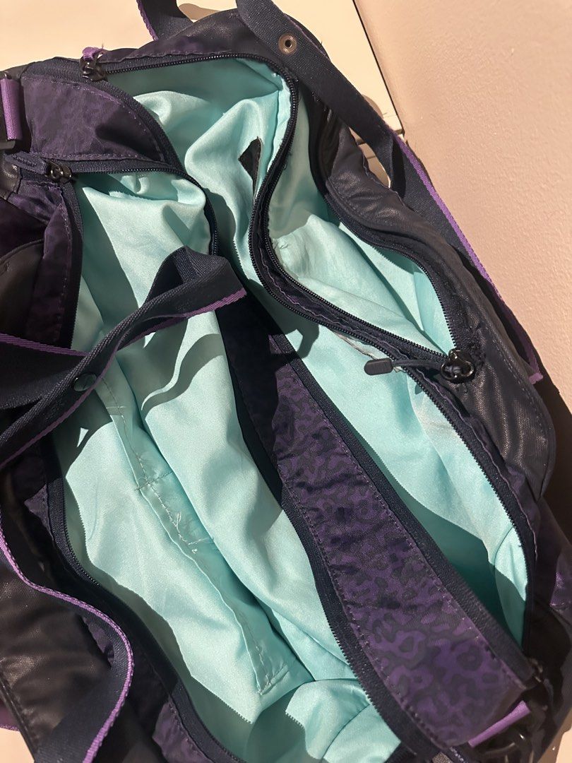 Nike Duffle Bag with Purple Accents (Category: Other Sports Equipment and Supplies) located in Manila. Submitted by kaitdeclutters (Listing ID 1435720880, Image 1). Description: - Nike duffle bag - Purple leopard print design - Spacious interior - Multiple compartments - Light blue lining - Includes shoulder strap and top handle - Nike logo visible - Stylish and functional for everyday use.