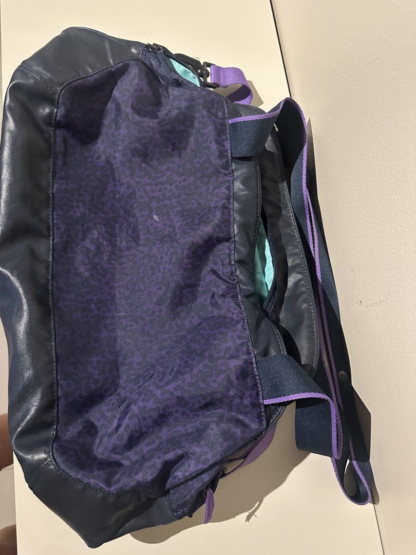 Nike Duffle Bag with Purple Accents (Category: Other Sports Equipment and Supplies) located in Manila. Submitted by kaitdeclutters (Listing ID 1435720880, Image 2). Description: - Nike duffle bag - Purple leopard print design - Spacious interior - Multiple compartments - Light blue lining - Includes shoulder strap and top handle - Nike logo visible - Stylish and functional for everyday use.