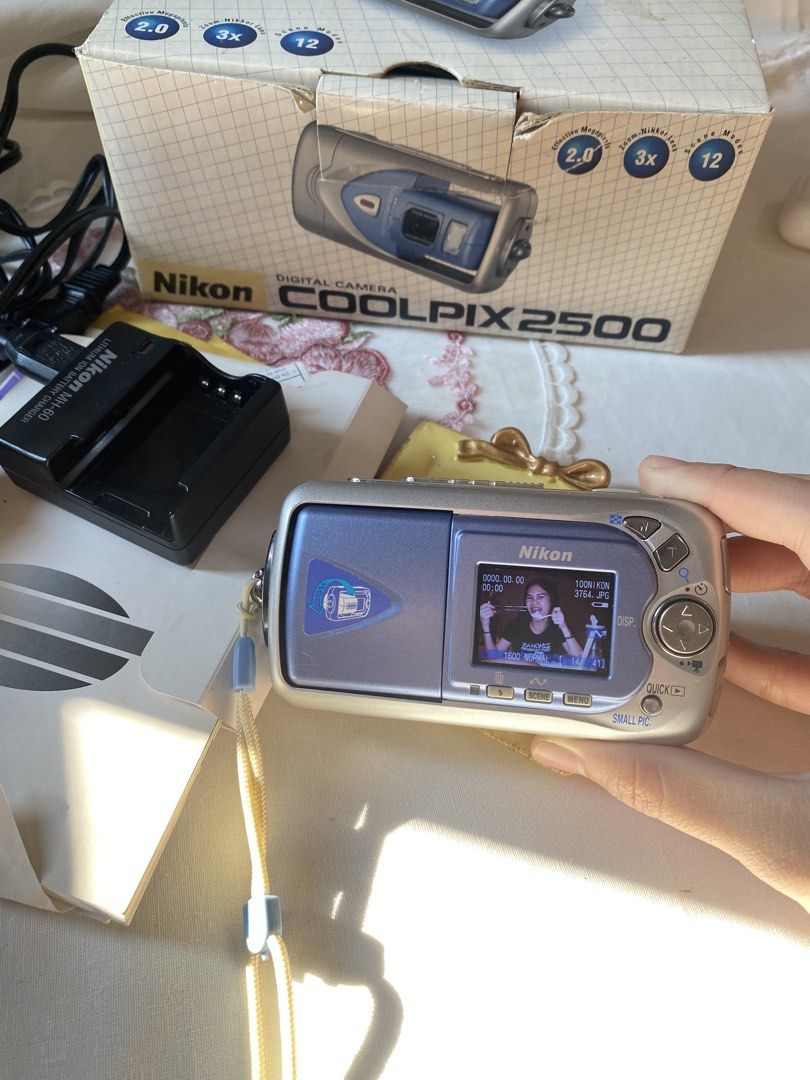 Nikon Coolpix 2500 (Category: Cameras) located in Quezon City. Submitted by helloclassiques (Listing ID 1435871888, Image 1). Description: Compact digicam with swivel/rotating lens! 📸 All buttons and flash are working. Clear lens and LCD— no dead pixel. 🫧☁️ Comes with its original box and accessories! 📦👾 Specs: 2 MP 3x optical zoom 1.5” LCD CCD sensor CF Card Memory Type With English language Ready to use! ✨ Inclusions: Orginal box with acces
