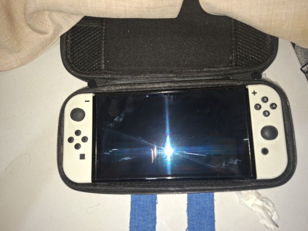 Nintendo Switch OLED White (Category: Nintendo) located in Caloocan City. Submitted by jezrenezon85402 (Listing ID 1435879476, Image 2). Description: - Japanese Nintendo Switch OLED model - White Joy-Cons - Includes a mario carrying case -256gb Sd card -Free Protective silicon case -Comes with all accesories except charger -No box Issue: Napatakan ng alcohol ung left speaker, medjo parang warerlogged ung tunog Price is Negotiable Rfs: For Gpu.