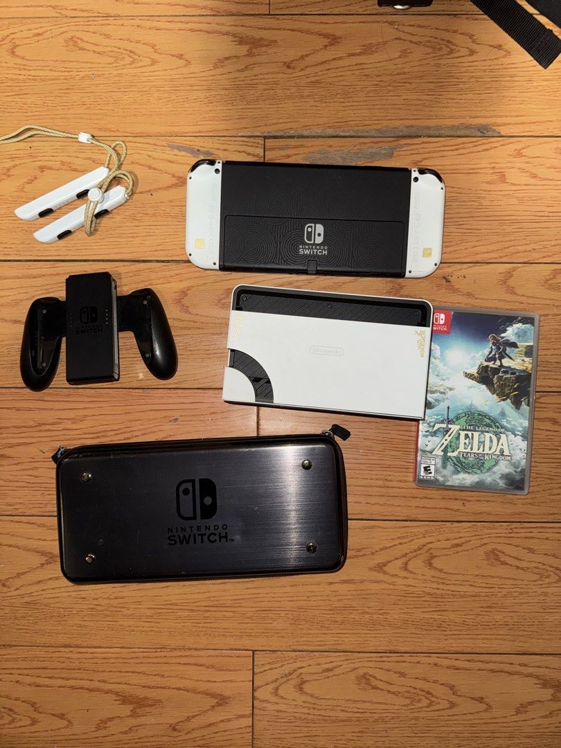Nintendo Switch OLED Zelda Edition (Category: Nintendo) located in Manila. Submitted by andr29951 (Listing ID 1435771058, Image 2). Description: - Nintendo Switch OLED Zelda Edition console - Matching Joy-Cons -NO BOX - Charging grip included - Carrying case included - "The Legend of Zelda: Tears of the Kingdom" game included - All accessories are present -Free Nintendo 30GB Micro SD Card included.