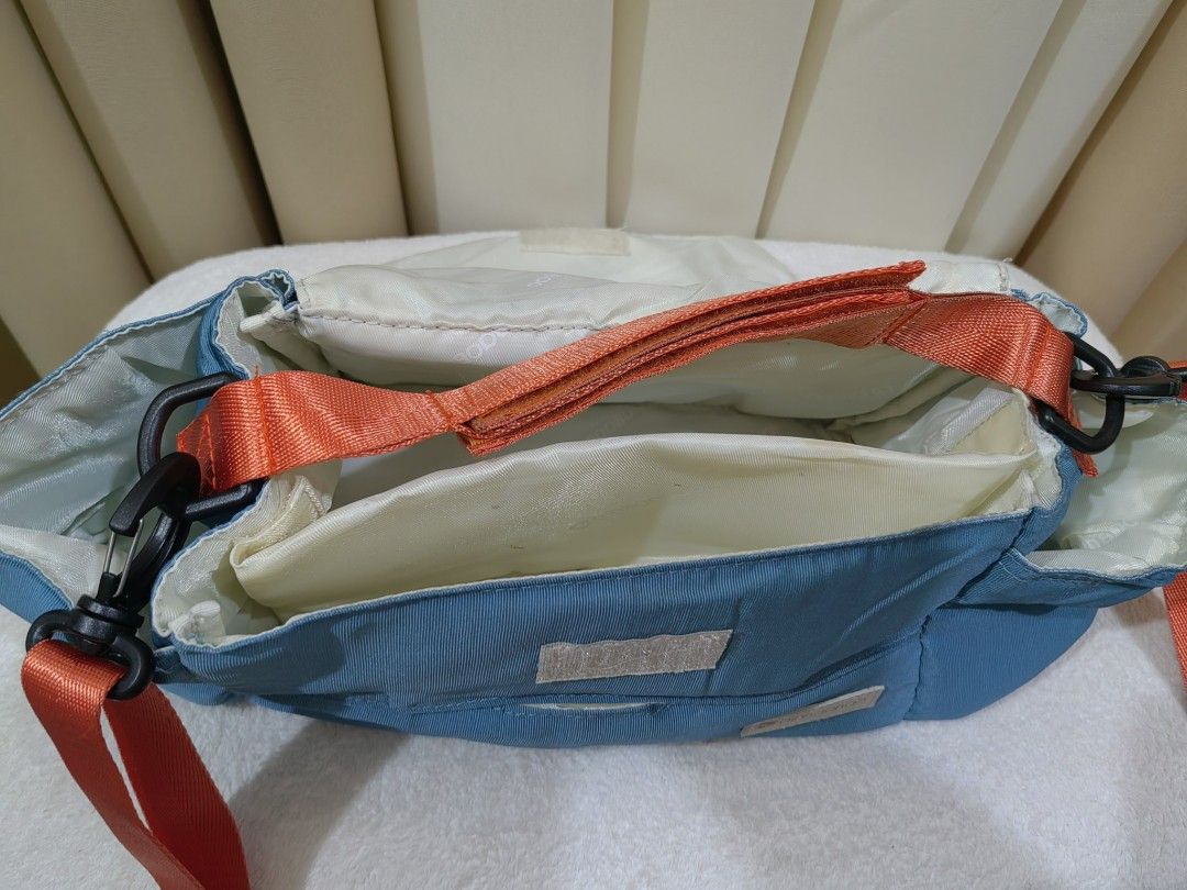 stroller bag organizet with sling (Category: Strollers) located in Makati City. Submitted by prelovedtreatedwithlove (Listing ID 1435832416, Image 3). Description: - Vibrant blue organizer bag - Features a patterned flap - Comes with an orange shoulder strap and handle - Spacious, light-colored interior - Includes tissue holder - Perfect for gateway with kiddo - Normal sign of use need wash A-102.