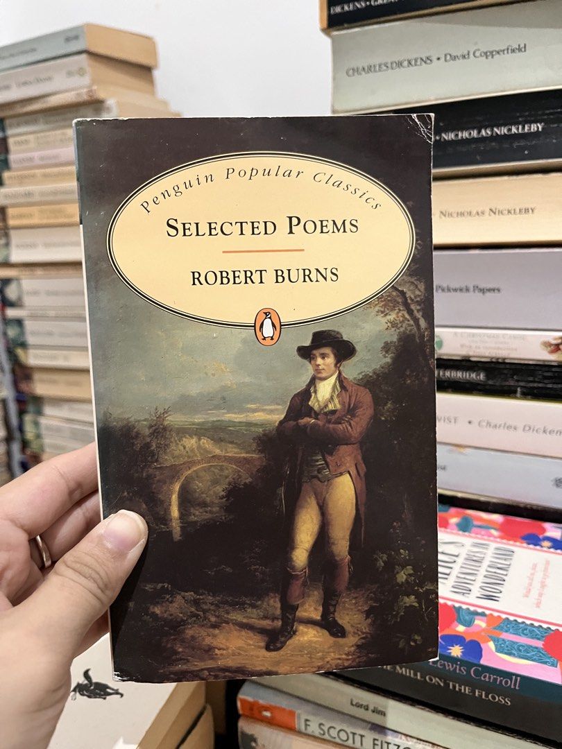 Penguin Popular Classics: Selected Poems by Robert Burns (Category: Storybooks) located in Maragondon. Submitted by quilljoylibrary (Listing ID 1435838436, Image 1). Description: - "Selected Poems" by Robert Burns - Published by Penguin Popular Classics - Cover illustration: Man in a red coat - Part of a classic literature collection - Spine shows some wear - Other books visible in the background.
