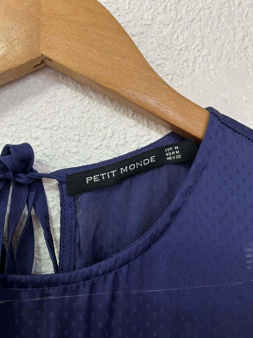 Petit Monde Navy Blue Dress (Category: Dresses) located in Baguio. Submitted by zealfish-f7c3 (Listing ID 1435772856, Image 2). Description: - Navy blue dress from Petit Monde. - Sleeveless design. - Gathered bodice and defined waist. - Subtle textured pattern. - Keyhole back with tie detail. - Knee-length. - Perfect for special occasions and nights out..