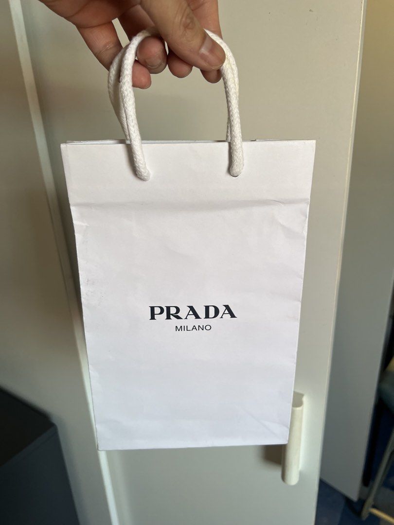Prada Milano Paper Bag (Category: Luxury Bags & Wallets) located in Makati City. Submitted by marckyboy (Listing ID 1435814041, Image 1). Description: - Authentic Prada Milano paper bag - White exterior with black Prada Milano logo - Features white rope handles - Perfect for small items or display.