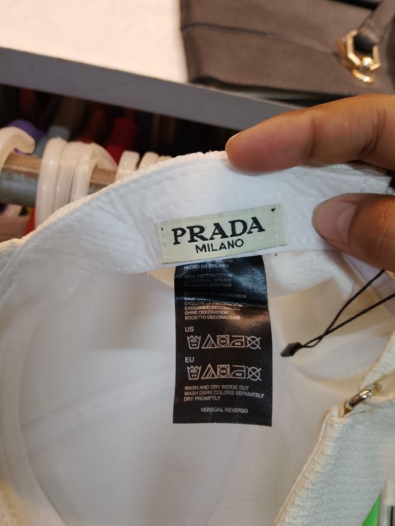 Prada White Cap (Category: Caps & Hats) located in Caloocan City. Submitted by natsyytwift (Listing ID 1435736558, Image 2). Description: - Authentic Prada cap - Color: White - Features the Prada logo - Textured pattern - Black trim on the brim - Prada Milano label inside - Made in Italy.