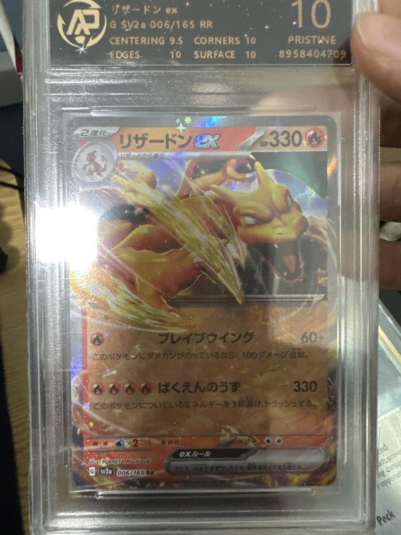 Pristine 10 Charizard (Category: Graded Cards) located in Singapore. Submitted by pangwei6767 (Listing ID 1435807199, Image 1). Description: - PSA Graded Charizard EX card - Grade: PSA 10 (Pristine) - Centering: 9.5 - Corners: 10 - Edges: 10 - Surface: 10 - Perfect addition to your Pokemon collection!.