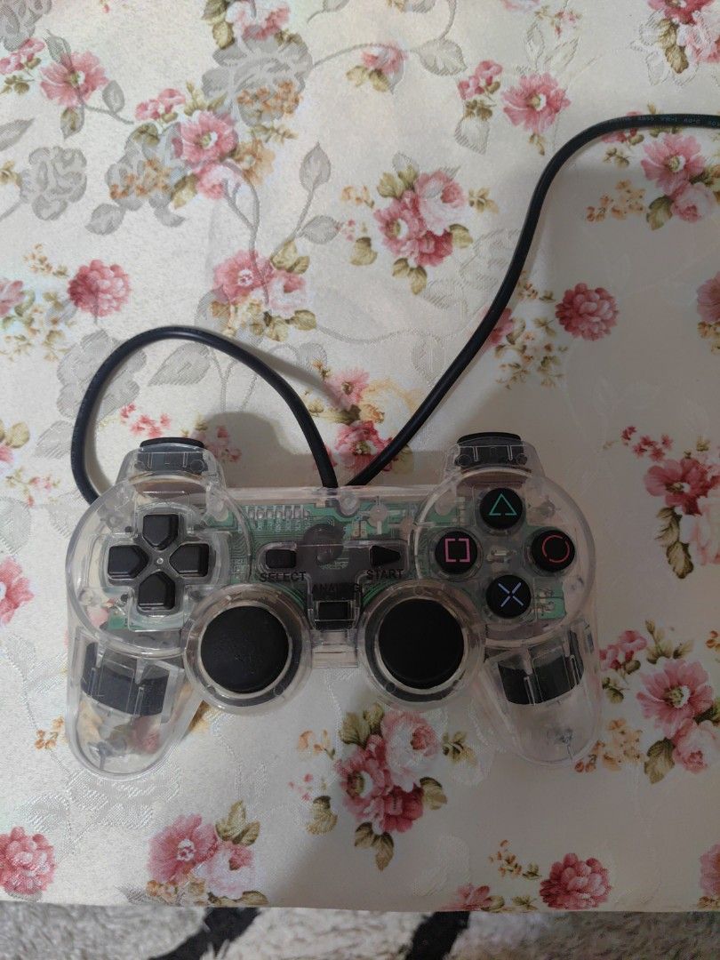 PS2 Controller Transparent (Category: Controllers) located in Senawang. Submitted by rarehorse_15cb6f (Listing ID 1435819715, Image 1). Description: - Wired PS2 controller - Transparent design - Standard button layout (directional pad, action buttons, analog sticks) - Black cable - Ready to use.